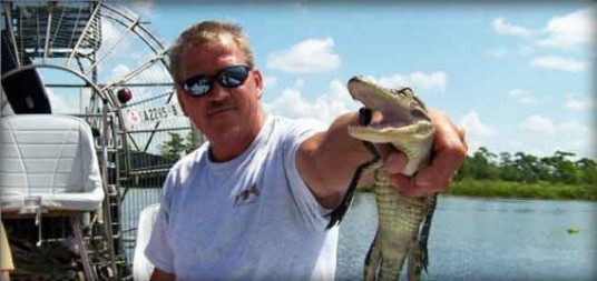 Gator holding pet an alligator swamp