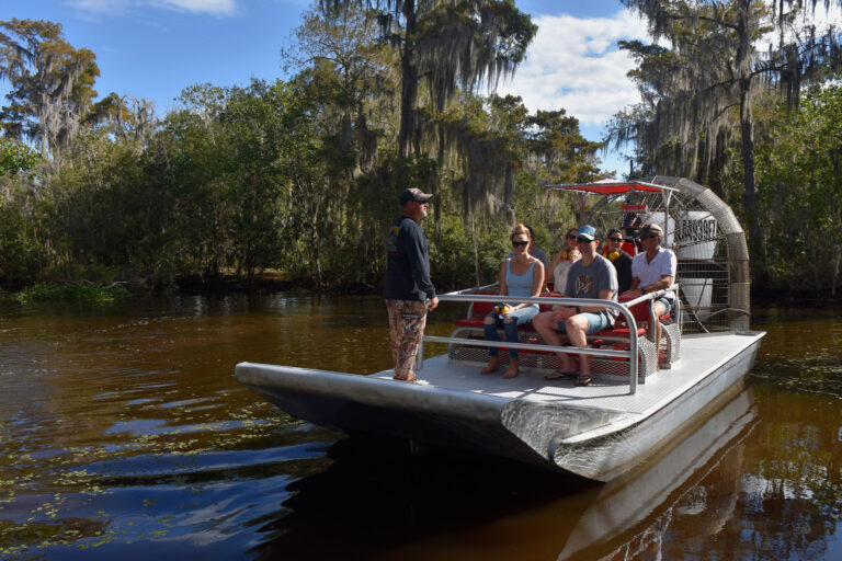group of people on an airboat for a december swamp tour on the best swamp tour