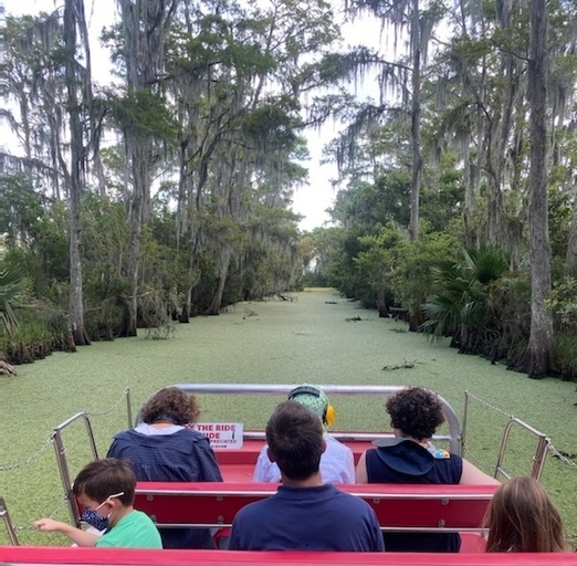 group on a boat in a swamp